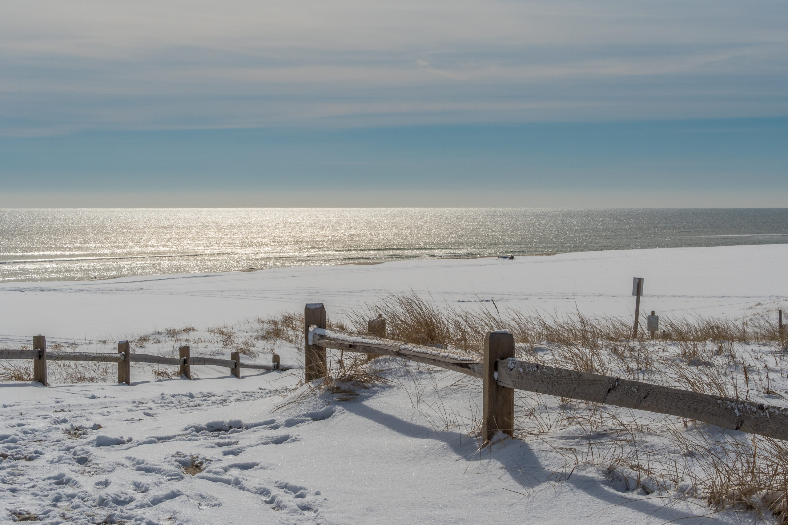 A calm and tranquil beach with a serene sky